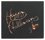 Textured black slate magnet with inscribed words "Happy Halloween"