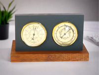 Natural cleft Black slate 2-hole Rangeley weather station with barometer and hygrometer with gold faces on a mahogany base